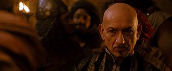 Movie still from “Prince of Persia: The Sands of Time” (2010), directed by Mike Newell – A man with a bald head and a beard; Close Up shot, Over the shoulder angle