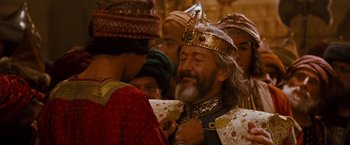 Movie still from “Prince of Persia: The Sands of Time” (2010), directed by Mike Newell – A man with a beard wearing a gold crown; Close Up shot, Over the shoulder angle