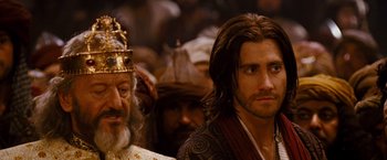 Movie still from “Prince of Persia: The Sands of Time” (2010), directed by Mike Newell – A man with long hair and a beard is looking at the camera; Close Up shot, Over the shoulder angle