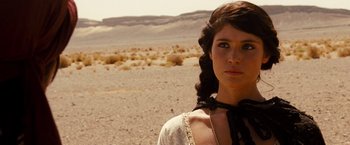Movie still from “Prince of Persia: The Sands of Time” (2010), directed by Mike Newell – A woman in a field wearing a white dress; Close Up shot, Over the shoulder angle