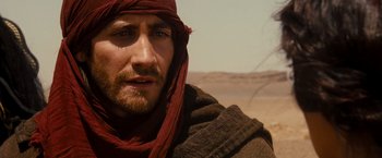 Movie still from “Prince of Persia: The Sands of Time” (2010), directed by Mike Newell – A person wearing a scarf; Close Up shot, Over the shoulder angle