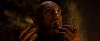 Movie still from “Prince of Persia: The Sands of Time” (2010), directed by Mike Newell – An old man with a bald head and a mustache; Close Up shot, High angle