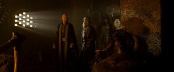 Movie still from “Prince of Persia: The Sands of Time” (2010), directed by Mike Newell – A group of men standing next to each other in a room; Medium shot, Low angle