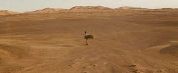 Movie still from “Prince of Persia: The Sands of Time” (2010), directed by Mike Newell – A person standing in the middle of the desert; Extreme Wide shot, High angle