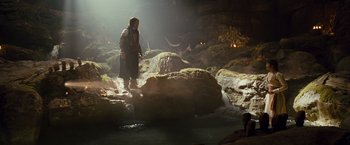 Movie still from “Prince of Persia: The Sands of Time” (2010), directed by Mike Newell – A man standing on a rock near a river; Wide shot, Low angle