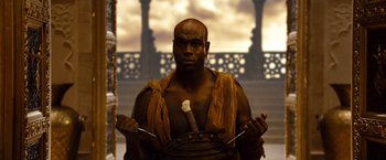 Movie still from “Prince of Persia: The Sands of Time” (2010), directed by Mike Newell – A man with a sword in his hands; Medium shot, Low angle