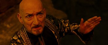 Movie still from “Prince of Persia: The Sands of Time” (2010), directed by Mike Newell – A man with a bald head and a mustache; Close Up shot, High angle