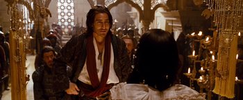 Movie still from “Prince of Persia: The Sands of Time” (2010), directed by Mike Newell – A man in a pirate costume standing next to a woman; Medium shot, Over the shoulder angle