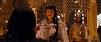 Movie still from “Prince of Persia: The Sands of Time” (2010), directed by Mike Newell – A woman is holding a mirror while another woman looks on; Close Up shot, Over the shoulder angle
