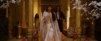 Movie still from “Prince of Persia: The Sands of Time” (2010), directed by Mike Newell – A woman and a man are walking through a room; Wide shot, Low angle