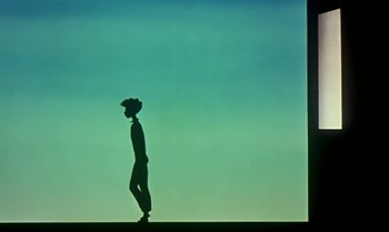 Movie still from “Princes and Princesses” (2000), directed by Michel Ocelot – A man standing on a skateboard in front of a blue sky; Wide shot, Low angle