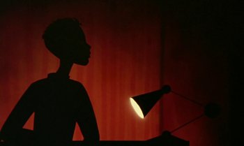 Movie still from “Princes and Princesses” (2000), directed by Michel Ocelot – A silhouette of a person holding a lamp; Close Up shot, Low angle