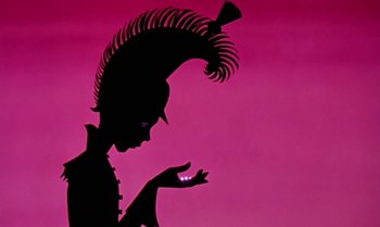 Movie still from “Princes and Princesses” (2000), directed by Michel Ocelot – A silhouette of a person wearing a hat and holding something in his hand; Close Up shot, Low angle