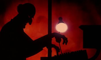 Movie still from “Princes and Princesses” (2000), directed by Michel Ocelot – A person playing a keyboard in front of a red background; Extreme Close Up shot, Low angle