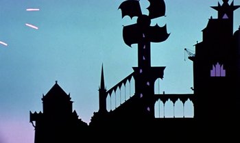 Movie still from “Princes and Princesses” (2000), directed by Michel Ocelot – The silhouette of a cross and a building is shown; Extreme Wide shot, Low angle