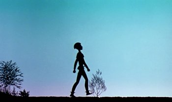 Movie still from “Princes and Princesses” (2000), directed by Michel Ocelot – A person walking on a hill with a tree in the background; Wide shot, Low angle