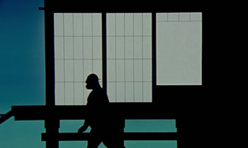 Movie still from “Princes and Princesses” (2000), directed by Michel Ocelot – A person walking in front of a window; Extreme Wide shot, Low angle