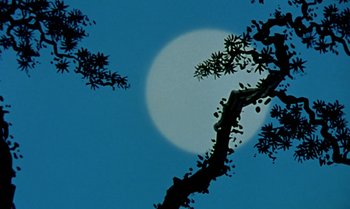 Movie still from “Princes and Princesses” (2000), directed by Michel Ocelot – A full moon setting behind a tree in the sky; Extreme Close Up shot, Low angle