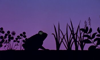 Movie still from “Princes and Princesses” (2000), directed by Michel Ocelot – A silhouette of a frog sitting in the grass at night; Wide shot, Low angle
