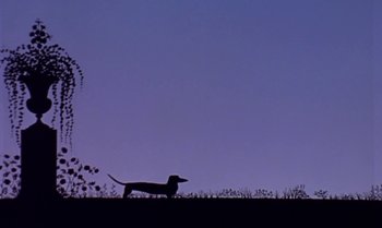 Movie still from “Princes and Princesses” (2000), directed by Michel Ocelot – A dog standing on top of a grass covered field; Extreme Wide shot, Low angle