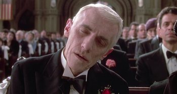Movie still from “Prizzi's Honor” (1985), directed by John Huston – An older man in a suit and bow tie; Close Up shot, Low angle