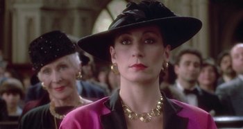 Movie still from “Prizzi's Honor” (1985), directed by John Huston – A person wearing a hat; Close Up shot, Over the shoulder angle