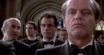 Movie still from “Prizzi's Honor” (1985), directed by John Huston – A group of men in suits and ties standing in a hallway; Close Up shot, Low angle