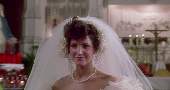 Movie still from “Prizzi's Honor” (1985), directed by John Huston – A woman in a wedding dress with a veil; Close Up shot, Over the shoulder angle