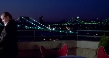 Movie still from “Prizzi's Honor” (1985), directed by John Huston – A view of a bridge lit up at night; Extreme Wide shot, High angle