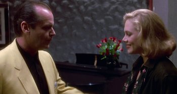 Movie still from “Prizzi's Honor” (1985), directed by John Huston – A man and a woman talking to each other; Medium shot, Over the shoulder angle