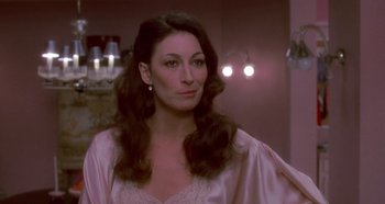 Movie still from “Prizzi's Honor” (1985), directed by John Huston – A woman with long hair wearing a pink robe; Close Up shot, Over the shoulder angle