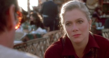 Movie still from “Prizzi's Honor” (1985), directed by John Huston – A person sitting in a chair; Close Up shot, Over the shoulder angle