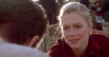 Movie still from “Prizzi's Honor” (1985), directed by John Huston – A woman sitting next to a man in a red shirt; Close Up shot, Over the shoulder angle