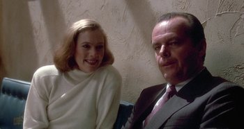 Movie still from “Prizzi's Honor” (1985), directed by John Huston – A man and a woman sitting next to each other; Close Up shot, Over the shoulder angle