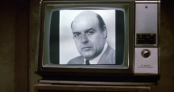 Movie still from “Prizzi's Honor” (1985), directed by John Huston – An old tv with a picture of a man on the screen; Close Up shot, Low angle