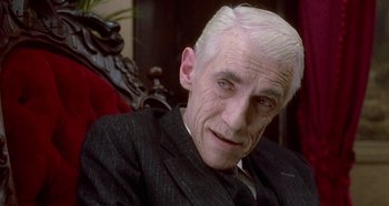 Movie still from “Prizzi's Honor” (1985), directed by John Huston – An older man with white hair sitting in a chair; Close Up shot, Low angle