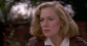 Movie still from “Prizzi's Honor” (1985), directed by John Huston – A person wearing a suit and tie; Close Up shot, Over the shoulder angle