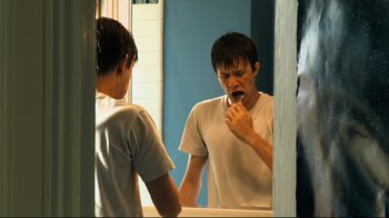 Movie still from “Project X” (2012), directed by Nima Nourizadeh – A man brushing his teeth in front of a mirror; Close Up shot, Over the shoulder angle