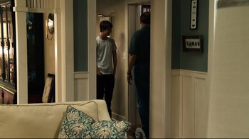 Movie still from “Project X” (2012), directed by Nima Nourizadeh – Two people standing in a living room next to each other; Wide shot, Over the shoulder angle