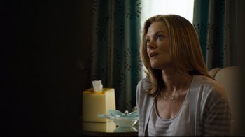 Movie still from “Project X” (2012), directed by Nima Nourizadeh – A woman sitting in front of a window looking up at the sky; Medium shot, Over the shoulder angle