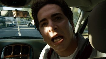Movie still from “Project X” (2012), directed by Nima Nourizadeh – A man in a car with his mouth wide open; Close Up shot, Low angle