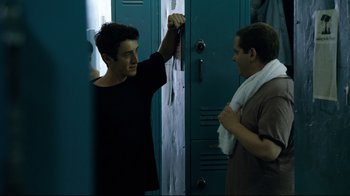 Movie still from “Project X” (2012), directed by Nima Nourizadeh – Two men standing next to each other in front of lockers; Medium shot, Over the shoulder angle