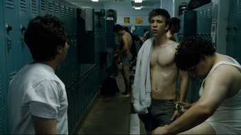 Movie still from “Project X” (2012), directed by Nima Nourizadeh – A group of young men standing in a locker room; Medium shot, Over the shoulder angle
