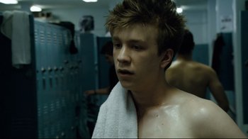 Movie still from “Project X” (2012), directed by Nima Nourizadeh – A young man wrapped in a towel in a locker room; Close Up shot, Over the shoulder angle