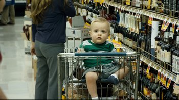 Movie still from “Project X” (2012), directed by Nima Nourizadeh – A baby sitting in a shopping cart in a store; Medium shot, High angle