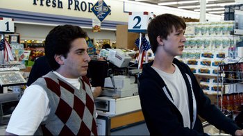 Movie still from “Project X” (2012), directed by Nima Nourizadeh – Two young men standing in front of a counter; Medium shot, Over the shoulder angle