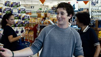 Movie still from “Project X” (2012), directed by Nima Nourizadeh – A man standing in front of a display case in a grocery store; Medium shot, Over the shoulder angle