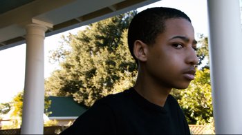 Movie still from “Project X” (2012), directed by Nima Nourizadeh – A young man's face with trees in the background; Close Up shot, Over the shoulder angle