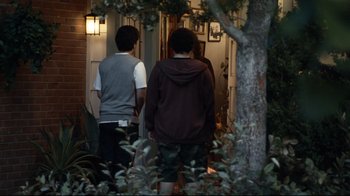 Movie still from “Project X” (2012), directed by Nima Nourizadeh – Two young men walking down the front steps of a house; Wide shot, Over the shoulder angle