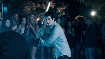 Movie still from “Project X” (2012), directed by Nima Nourizadeh – A man holding a baseball bat in a crowd of people; Medium shot, Over the shoulder angle